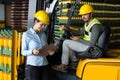 Factory workers checking record on clipboard in factory Royalty Free Stock Photo