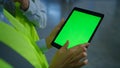 Factory workers checking seen screen tablet analysing information hands closeup