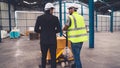 Factory workers deliver boxes package on a pushing trolley in the warehouse . Royalty Free Stock Photo