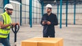 Factory workers deliver boxes package on a pushing trolley in the warehouse . Royalty Free Stock Photo