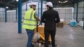 Factory workers deliver boxes package on a pushing trolley in the warehouse . Royalty Free Stock Photo