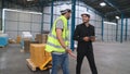 Factory workers deliver boxes package on a pushing trolley in the warehouse . Royalty Free Stock Photo