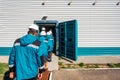 Factory workers enter to armored door of bomb shelter