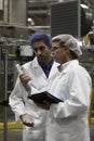 Factory workers inspecting bottled water at bottling plant