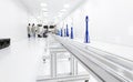 Factory workers in white lab suits and face masks, sitting on the chairs, producing tv sets with some modern equipment in a clean Royalty Free Stock Photo