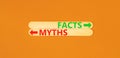 Facts or myths symbol. Concept word Myths and Facts on beautiful wooden stick. Beautiful orange table orange background. Business