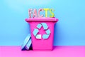 Facts text on a colorful recycling bin, highlighting the concept of information recycling. Royalty Free Stock Photo