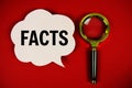 Facts text with speech bubble and magnifying glass on red background Royalty Free Stock Photo