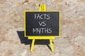 Facts vs myths symbol. Concept words Facts vs myths on black chalk blackboard on a beautiful stone background. Business, financial