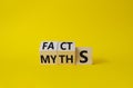 Facts vs Myths symbol. Wooden cubes with words Myths and Facts. Beautiful yellow background. Business and Facts vs Myths concept. Royalty Free Stock Photo