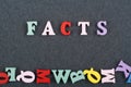 FACTS word on black board background composed from colorful abc alphabet block wooden letters, copy space for ad text. Learning