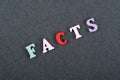 FACTS word on black board background composed from colorful abc alphabet block wooden letters, copy space for ad text