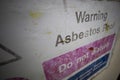 Faded Asbestos roof warning sign