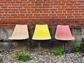 3 faded colorful plastic chairs