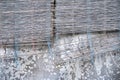 Faded grey concrete wall and wooden window blind texture. Shabby material photo. Weathered concrete and bamboo