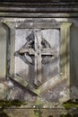 Faded wooden cross on a stone shield background. Derbyshire, UK. Royalty Free Stock Photo