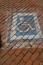 Cobblestone road with a handicapped parking space Royalty Free Stock Photo