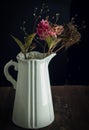 Faded hydrangea flower in a vintage vase