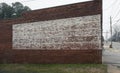 Faded painted sign on rustic old brick wall texture store or building Royalty Free Stock Photo