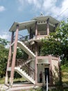 faded pink three-story cylindrical building on nature background