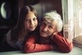 Faded portrait of a little girl and her grandmother. Love.