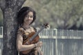 Faded portrait of young woman holding violin outdoors