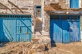 Faded and weathered white wall and stairs, blue painted door, Greece. Traditional architecture, details, authentic Royalty Free Stock Photo