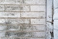 Faded white paint on the exterior brick wall of an abandoned building Royalty Free Stock Photo