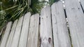 Faded Wooden privacy fence looking through cracks