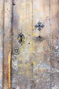 Faded worn old door with key holes