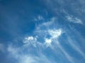 A fading, dissolving feather cloud. A cirrus clouds against a blue background. Relaxed cotton wool distributes the smoke into a Royalty Free Stock Photo