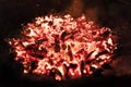 Fading embers from a wood burning fire at night. Royalty Free Stock Photo