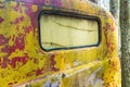 Fading yellow paint on an old truck cab. Royalty Free Stock Photo