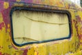 Fading yellow paint on an old truck cab.