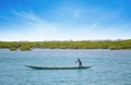 Fadiouth, Senegal, AFRICA - April 26, 2019: Unidentified Senegalese Men man rides a typical wooden canoe in a sea lagoon and