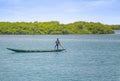Fadiouth, Senegal, AFRICA - April 26, 2019: Unidentified Senegalese Men man rides a typical wooden canoe in a sea lagoon and