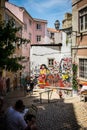 Fado graffiti in alley in Lisbon Portugal with a gentleman sitting in the shade Royalty Free Stock Photo