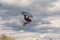 Fagersta, Sweden - Maj 07, 2020: Teen boy make an extreme jump on wakeboarding, around there are a lot of splashes. Upside down on