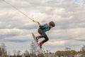 Fagersta, Sweden - Maj 07, 2020: Teen girl make an extreme jump on wakeboarding, around there are a lot of splashes. Upside down