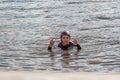 Teenager wakeboarder fells into the water after an unsuccessful jump