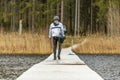 Fagersta, Sweden - Maj 01, 2020: Teenager wakeboarding crawled out of the water and goes over the bridge