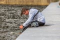Fagersta, Sweden - Maj 01, 2020: Teenager wakeboarding sits on the bridge after falling into the water after an unsuccessful jump