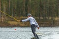 Wakeboarder surfing across a lake in spring in Sweden