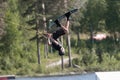 Wakeboarder hanging up side down off a kicker