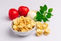 Fagottini Tortellini pasta in a white bowl isolated in white background, soft light, studio photo Royalty Free Stock Photo