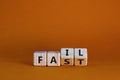 Fail fast symbol. Business and design concept. Turned wooden cubes with words `fail fast` on beautiful orange background, copy