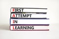 FAIL first attempt in learning symbol. Books with words FAIL first attempt in learning. Beautiful white table, white background, Royalty Free Stock Photo