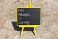 FAIL first attempt in learning symbol. Concept words FAIL first attempt in learning on black chalk blackboard on a beautiful stone Royalty Free Stock Photo