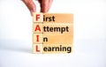 FAIL first attempt in learning symbol. Wooden blocks with words FAIL first attempt in learning. Beautiful white table, white Royalty Free Stock Photo