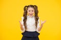 Failed again. Furious schoolgirl. Little schoolgirl gesturing her fists with anger on yellow background. Small